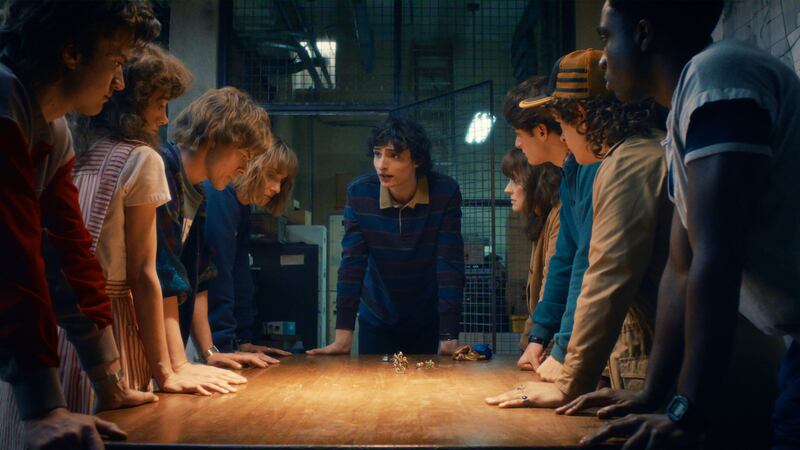 (L-R) Joe Keery as Steve Harrington, Natalia Dyer as Nancy Wheeler, Charlie Heaton as Jonathan Byers, Maya Hawke as Robin Buckley, Finn Wolfhard as Mike Wheeler, Winona Ryder as Joyce Byers, Noah Schnapp as Will Byers, Gaten Matarazzo as Dustin Henderson, and Caleb McLaughlin as Lucas Sinclair.