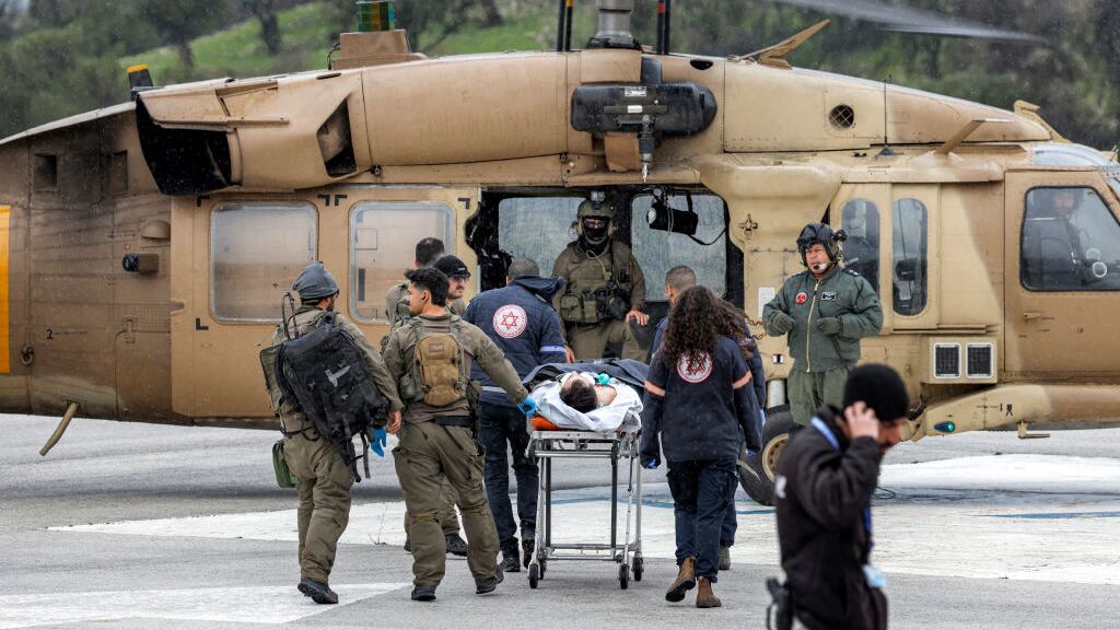 An Israeli medical team transports a person wounded in a rocket attack fired from southern Lebanon at Ziv hospital in Israel’s northern city of Safed on February 14, 2024.