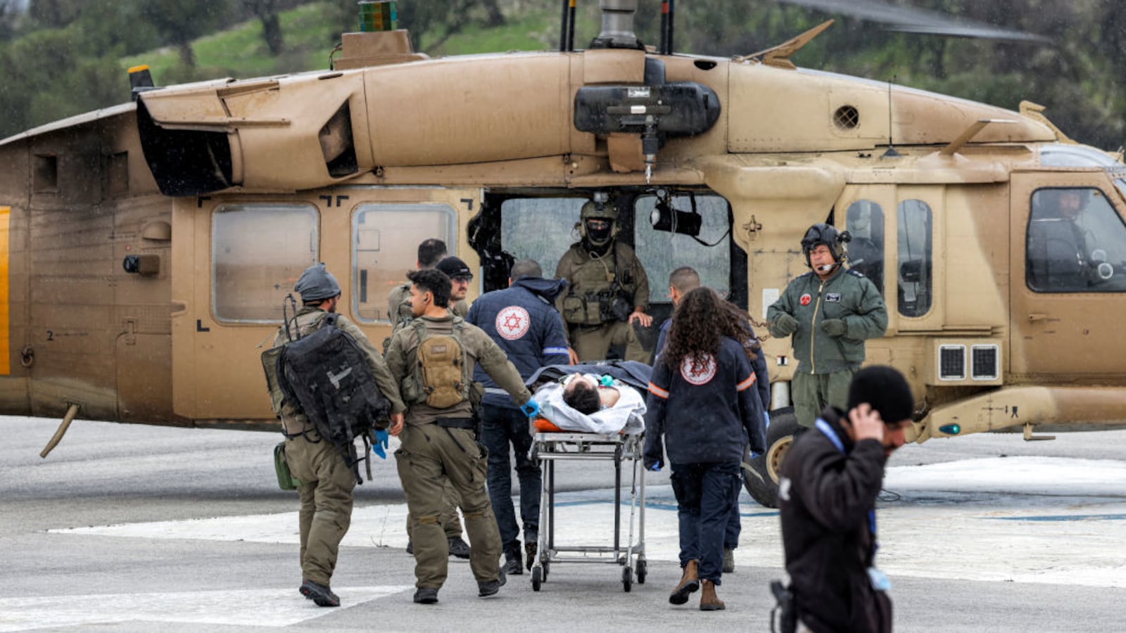 An Israeli medical team transports a person wounded in a rocket attack fired from southern Lebanon at Ziv hospital in Israel’s northern city of Safed on February 14, 2024.