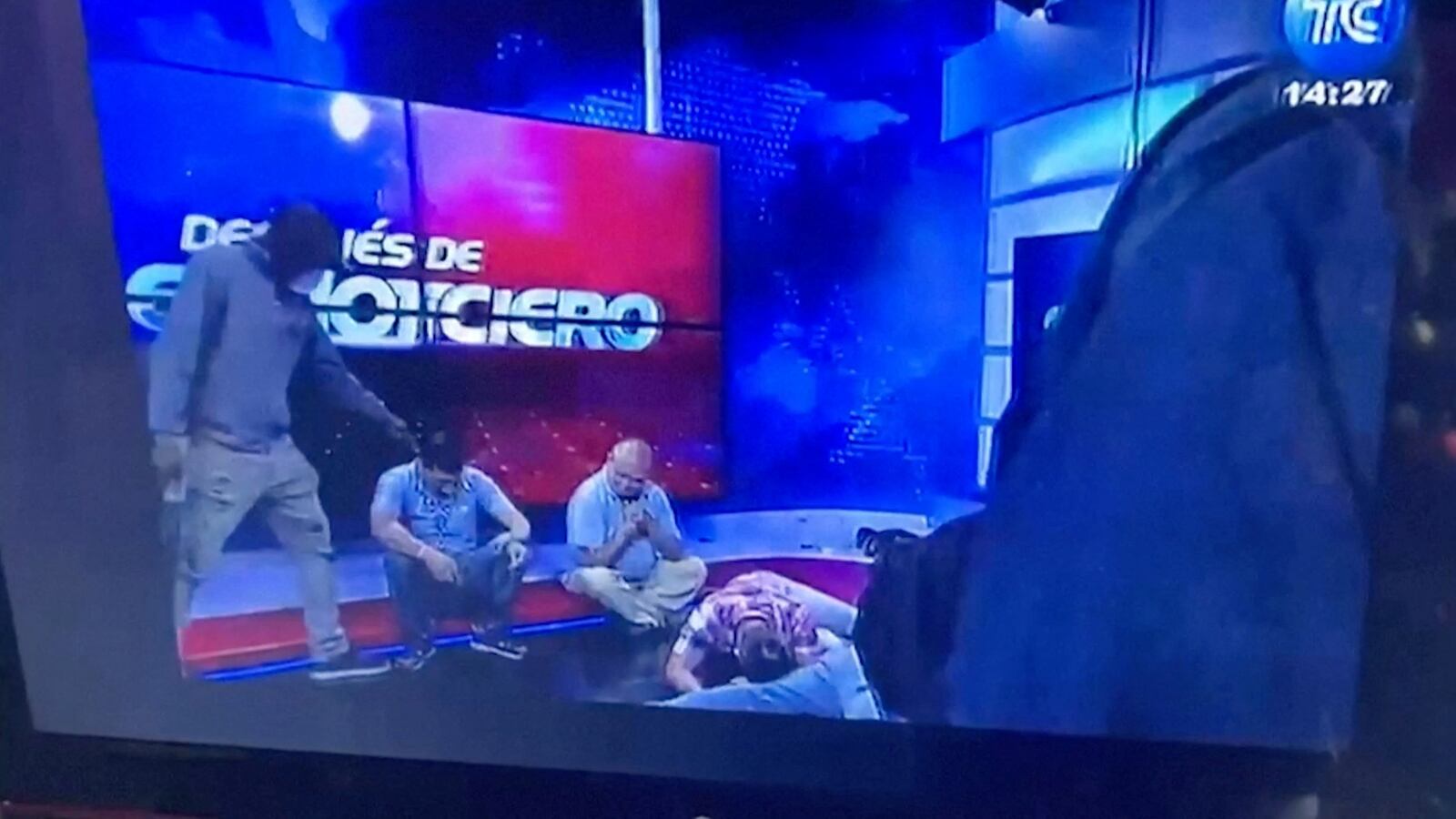 Workers lie on the floor as armed men take over a tv studio in Ecuador.