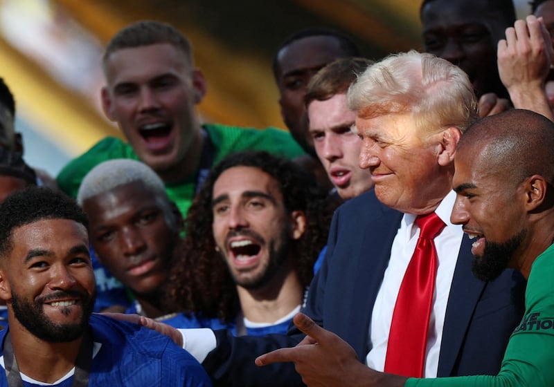 Soccer Football - FIFA Club World Cup - Final - Chelsea v Paris St Germain - MetLife Stadium, East Rutherford, New Jersey, U.S. - July 13, 2025 Chelsea's Reece James and teammates celebrate with the trophy alongside U.S. President Donald Trump after winning the FIFA Club World Cup REUTERS/Hannah Mckay
