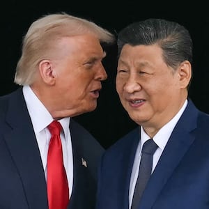 US President Donald Trump (L) talks to China's President Xi Jinping.