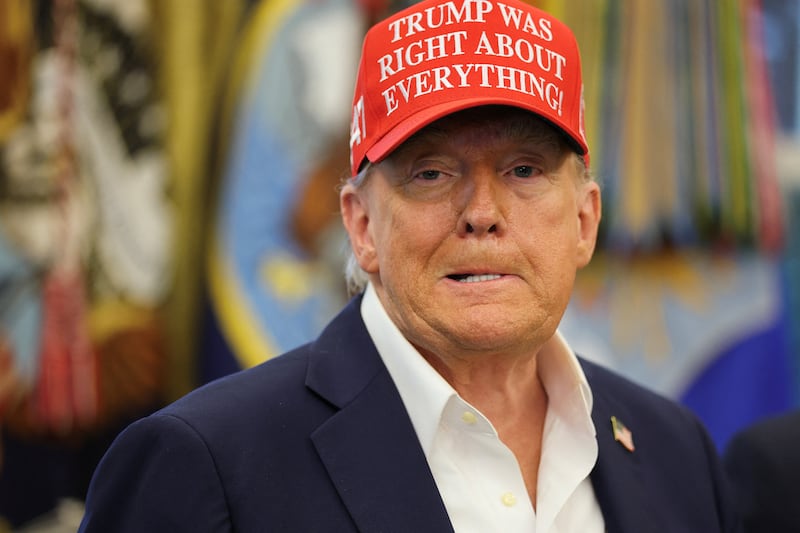 U.S. President Donald Trump wears a 'Trump Was Right About Everything!' hat, as he makes an announcement on the 2026 FIFA World Cup, in the Oval Office at the White House in Washington, D.C., U.S., August 22, 2025. REUTERS/Jonathan Ernst