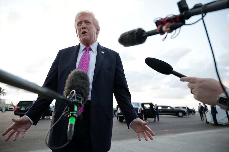 President Donald Trump speaks to members of the press after he landed at West Palm Beach International Airport on October 17, 2025 in West Palm Beach, Florida.