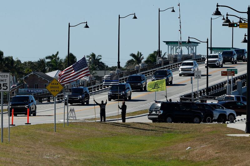 PALM BEACH, FLORIDA - DECEMBER 03: Supporters wave at President-elect Donald Trump's motorcade as it passes along Southern Boulevard on Bingham Island as it returns to Trump's Mar-a-lago Club on December 03, 2024 in Palm Beach, Florida. Trump attended a memorial service on Tuesday for three Palm Beach County sheriff's deputies killed last month in a roadside crash. (Photo by Chip Somodevilla/Getty Images)