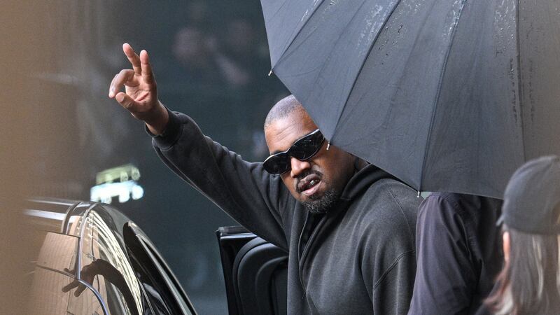 TOPSHOT - US rapper and producer Kanye West gestures upon arriving at Shanghai Pudong International Airport on July 11, 2025. Kanye West will hold a concert in Shanghai on July 12. (Photo by Hector RETAMAL / AFP) (Photo by HECTOR RETAMAL/AFP via Getty Images)
