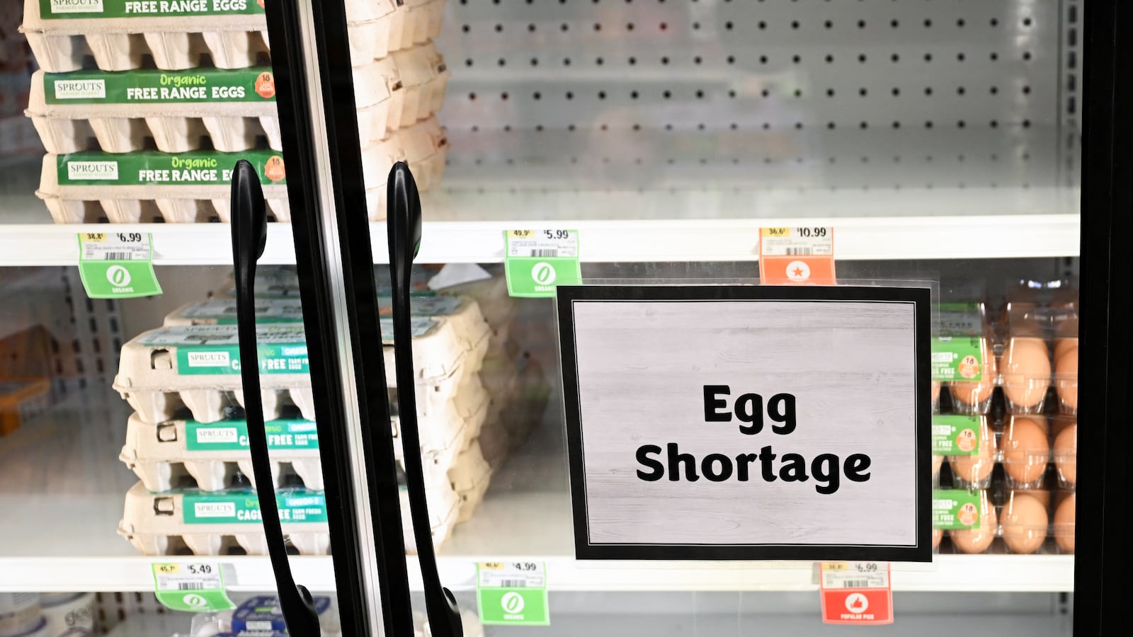 Egg shortage signage is displayed on partially empty shelves at a Sprouts Farmer's Market grocery store in Lawndale, California on January 2, 2025.