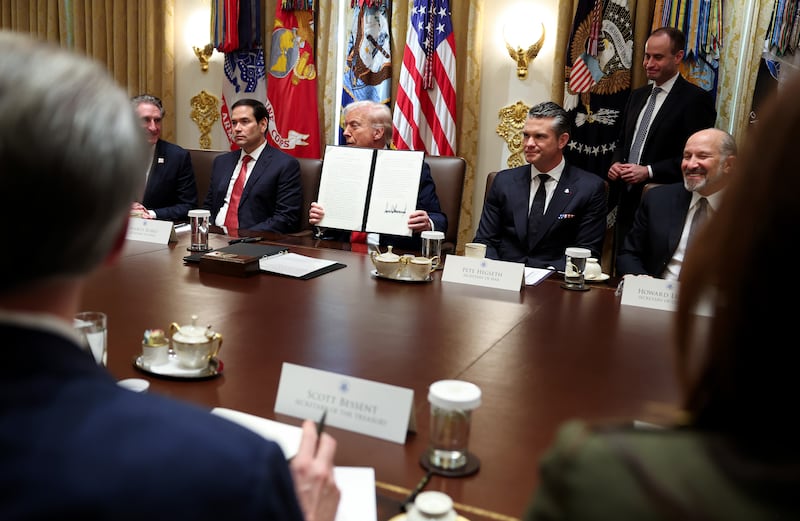 WASHINGTON, DC - OCTOBER 09: U.S. President Donald Trump holds up a Presidential Proclamation for Columbus Day during a Cabinet meeting at the White House on October 09, 2025 in Washington, DC. Trump spoke on the Israel and Hamas ceasefire and hostage deal, prescription drug costs and the government shutdown during the meeting. Trump was joined by Interior Secretary Doug Burgum, Secretary of State Marco Rubio, Defense Secretary Pete Hegseth and Commerce Secretary Howard Lutnick. (Photo by Anna Moneymaker/Getty Images)