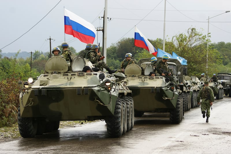 A column of Russian troops prepares to leave the checkpoint at a bridge over the Inguri River in Western Georgia October 8, 2008. Russian troops started pulling back from a buffer zone outside Georgia's breakaway South Ossetia region on Wednesday, two months after a brief war that fuelled tension between Moscow and the West.