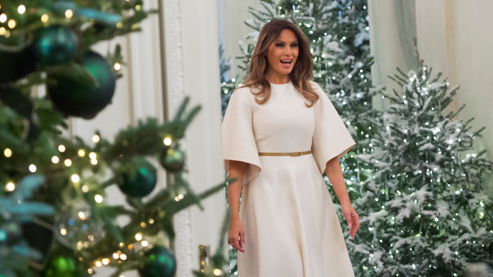 US First Lady Melania Trump walks into the East Room as she tours Christmas decorations at the White House in Washington, DC, November 27, 2017.