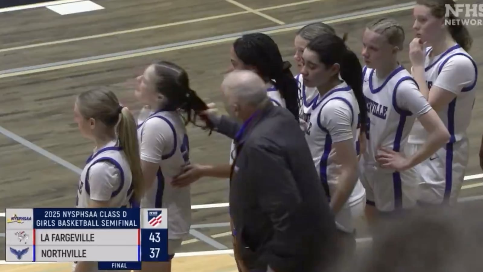 Coach Jim Zullo pulls a girl’s hair.