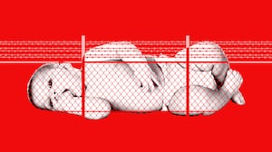 Baby behind a chain link fence with barbed wire