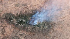 NEW MEXICO, USA - 17 MAY 2026: Satellite view of the Seven Cabins fire in the Capitan Mountain Wilderness, New Mexico. The blaze, which erupted on May 14 after a Trans Aero MedEvac medical transport plane crashed along its flightpath from Roswell to Sierra Blanca Regional Airport, has scorched nearly 9,000 acres and remains uncontained, sending thick smoke plumes across Lincoln County. Imaged 17 May 2026. (Photo by Gallo Images/Orbital Horizon/Copernicus Sentinel Data 2026)