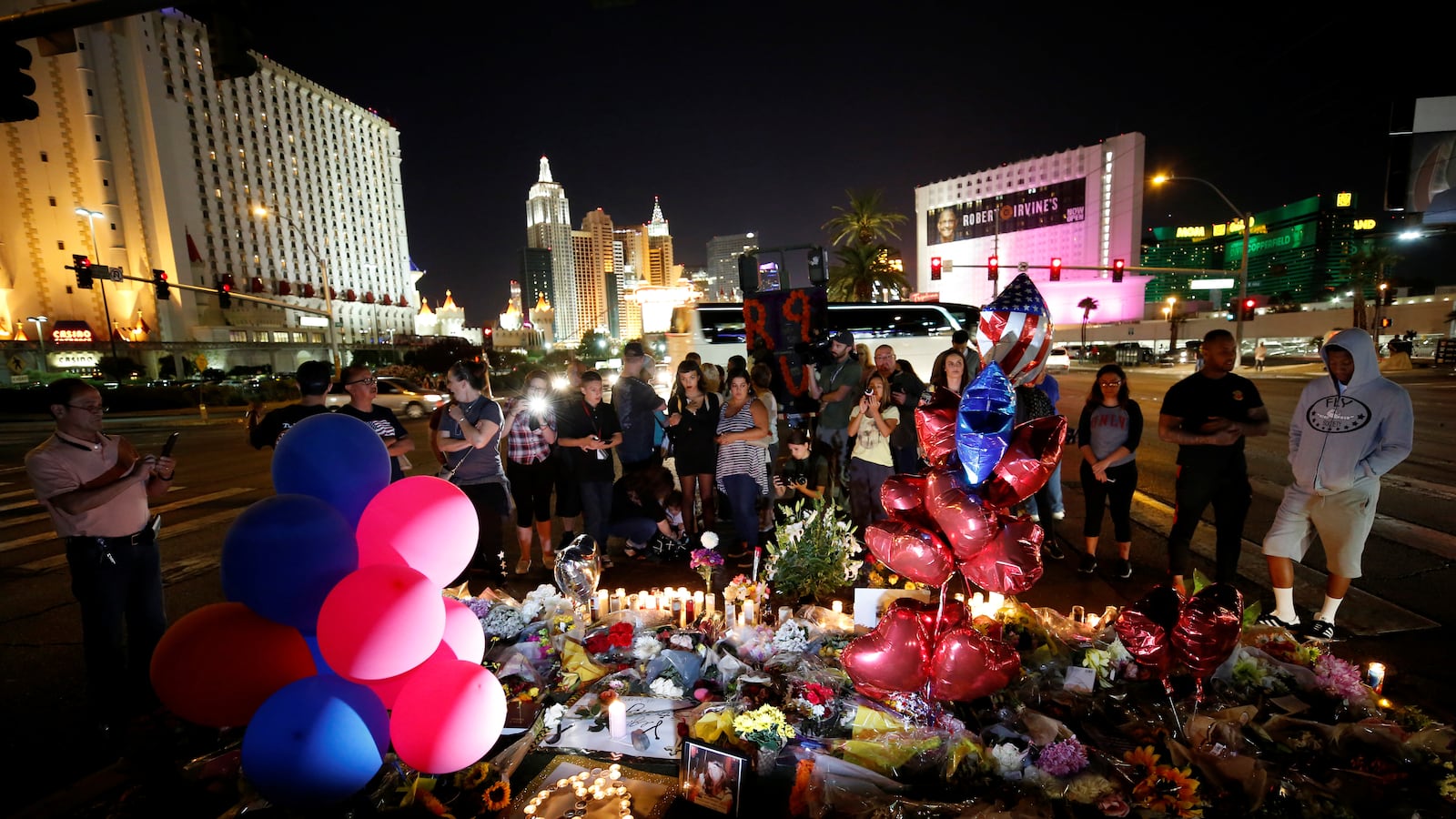 People gather at a makeshift memorial in the middle of Las Vegas Boulevard following the mass shooting in Las Vegas, Nevada, U.S., October 4, 2017.
