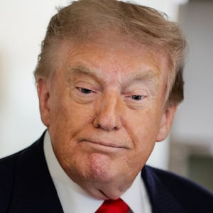 U.S. President Donald Trump reacts as he speaks to reporters aboard Air Force One en route to Michigan, U.S., July 27, 2026. REUTERS/Evan Vucci