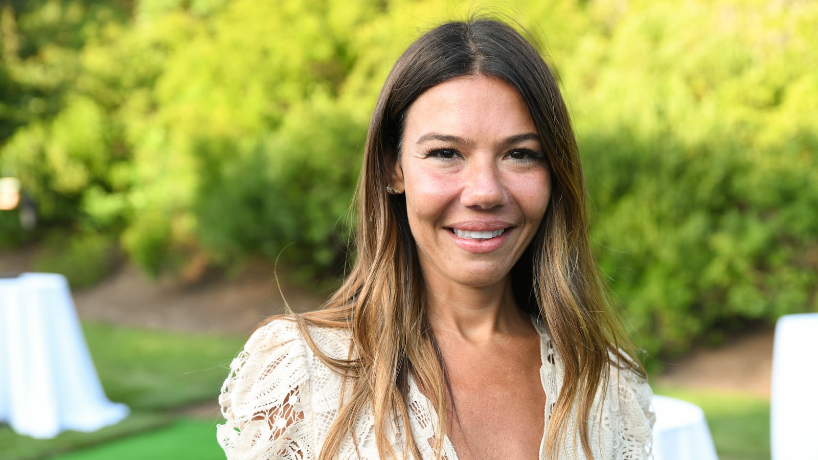 A photo of a smiling Libbie Mugrabi at an outdoor event.
