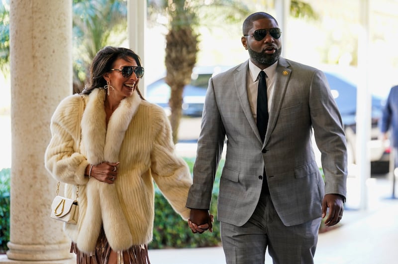 Erika and Byron Daniels walk hand in hand.