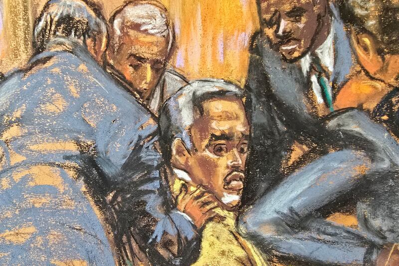 Defense lawyers comfort Sean "Diddy" Combs.