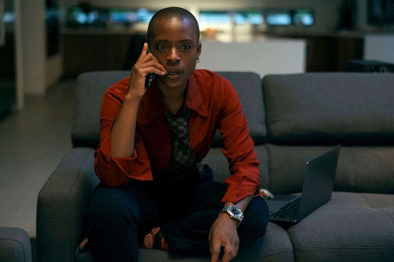 ’Nia Miller on a couch on the phone in a still from ‘The Fall of the House of Usher’