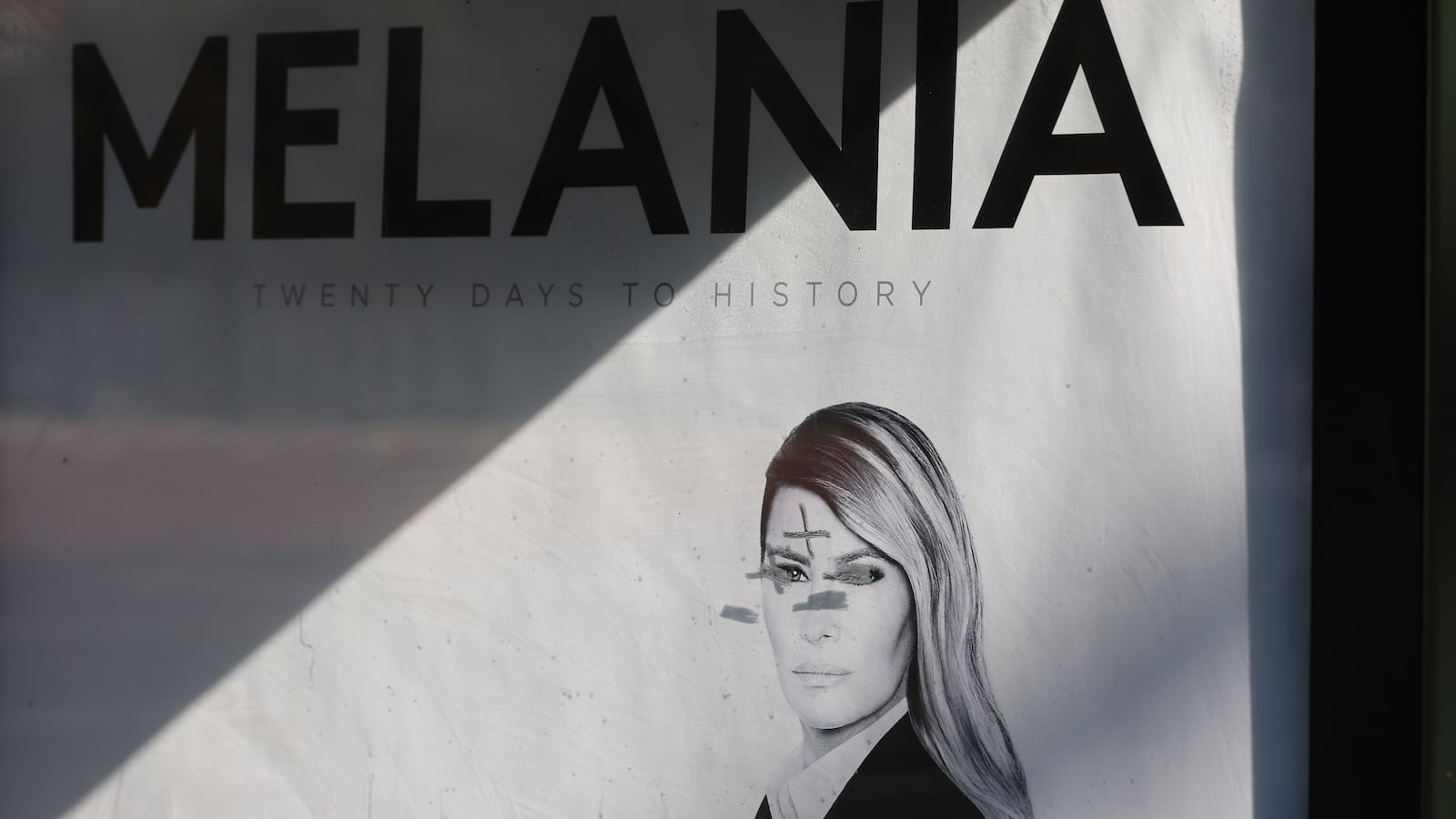 A view of a defaced bus stop advertisement for the new documentary film about First Lady Melania Trump at Exposition Park in Los Angeles