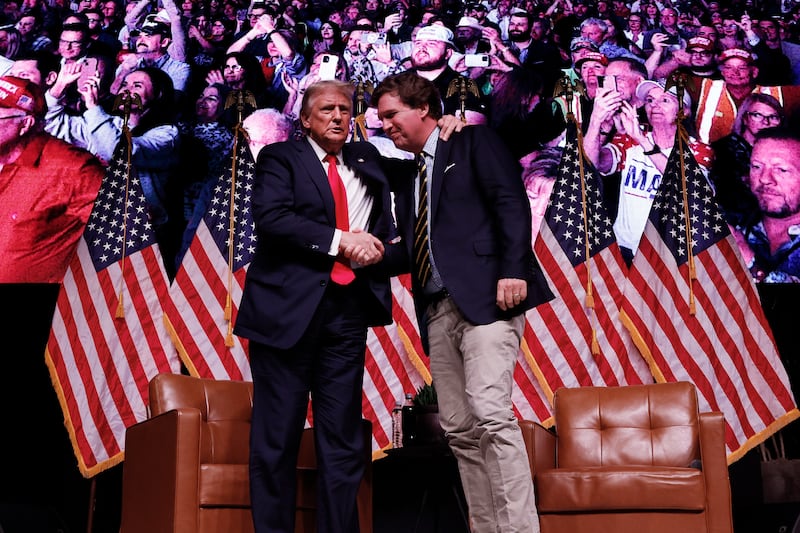 PHOENIX, ARIZONA - OCTOBER 31: Republican presidential nominee, former President Donald Trump shakes hands with Tucker Carlson at the conclusion of a conversation during Carlson's Live Tour at the Desert Diamond Arena on October 31, 2024 in Phoenix, Arizona. With less than a week until Election Day, Trump is campaigning for re-election in New Mexico and the battleground states of Nevada and Arizona on Thursday. (Photo by Chip Somodevilla/Getty Images)