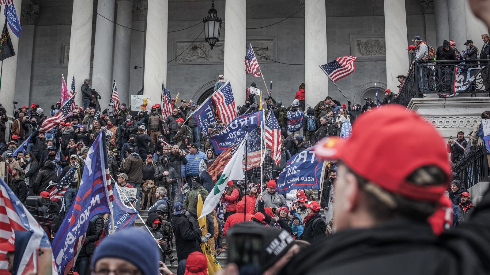 Trump supporters take the steps on the east side of the US Capitol building.