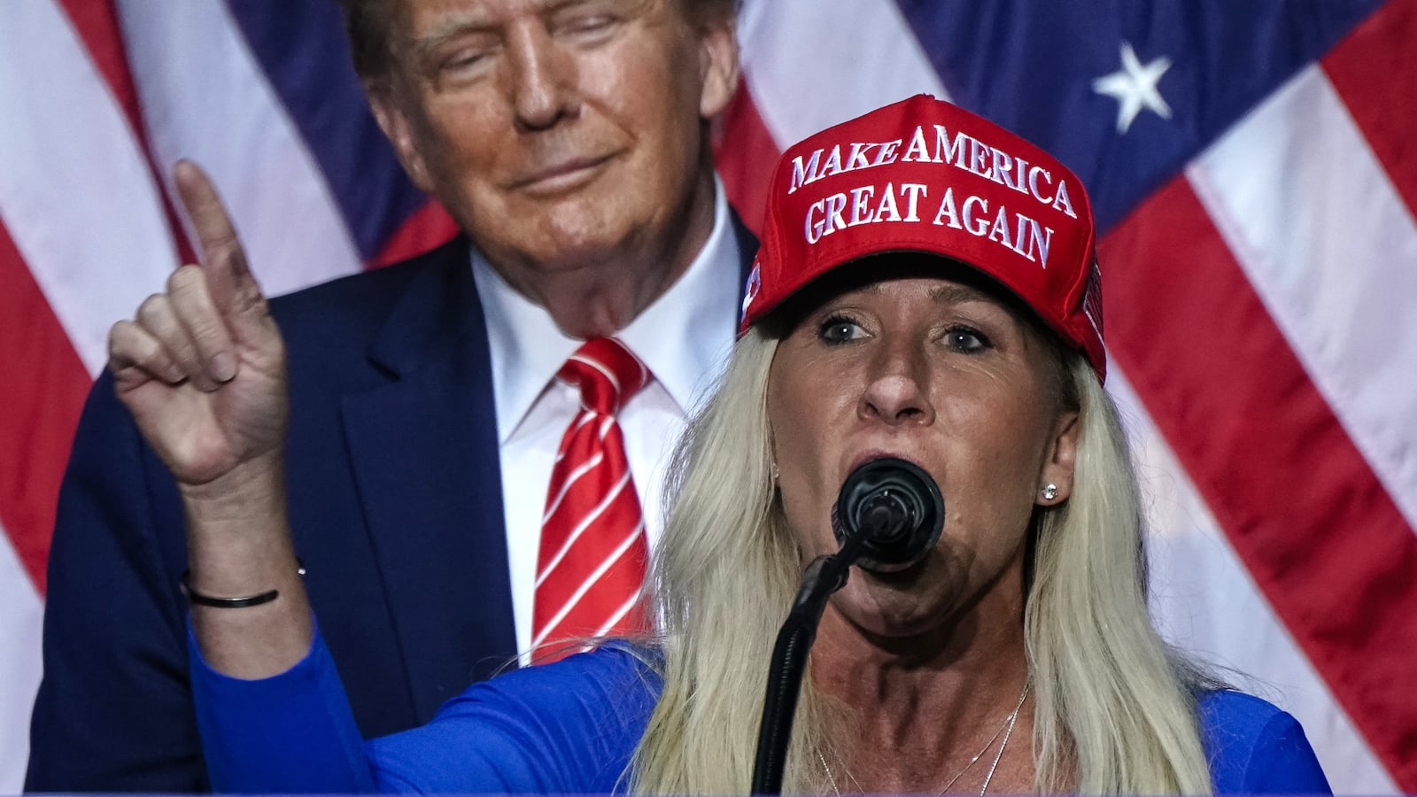 Marjorie Taylor Greene (R) speaks Donald Trump at a campaign event in Rome, Georgia, on March 9, 2024. (Photo by Elijah Nouvelage / AFP) (Photo by ELIJAH NOUVELAGE/AFP via Getty Images)