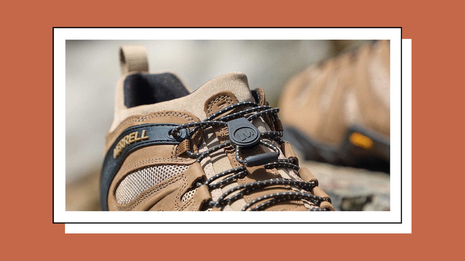 A pair of brown and black hiking shoes from Merrell.