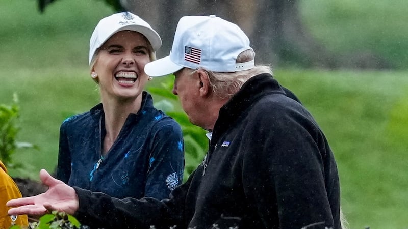 U.S. Interior Secretary Doug Burgum and Executive assistant to U.S. President Donald Trump Natalie Harp speak with Donald Trump during a visit at a golf course at Hains Point in Washington, D.C., U.S., June 28, 2026. REUTERS/Ken Cedeno     TPX IMAGES OF THE DAY