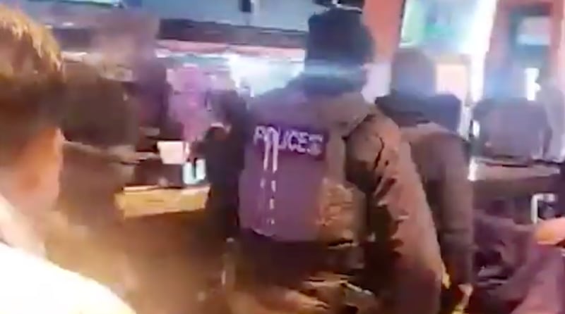ICE agents are escorted out of Cancun Mexican Grill & Cantina.