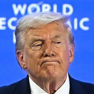 TOPSHOT - US President Donald Trump looks on during the World Economic Forum (WEF) annual meeting in Davos on January 21, 2026. The World Economic Forum takes place in Davos from January 19 to January 23, 2026. (Photo by Fabrice COFFRINI / AFP via Getty Images)