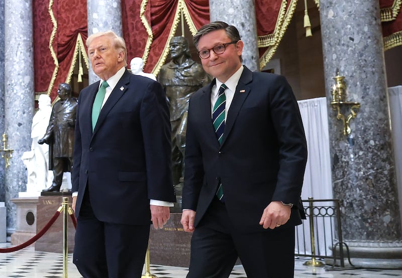 Speaker Mike Johnson, pictured with President Donald Trump on March 17, defended the president voting by mail in the Florida special election despite Trump attacking vote-by-mail as "cheating."