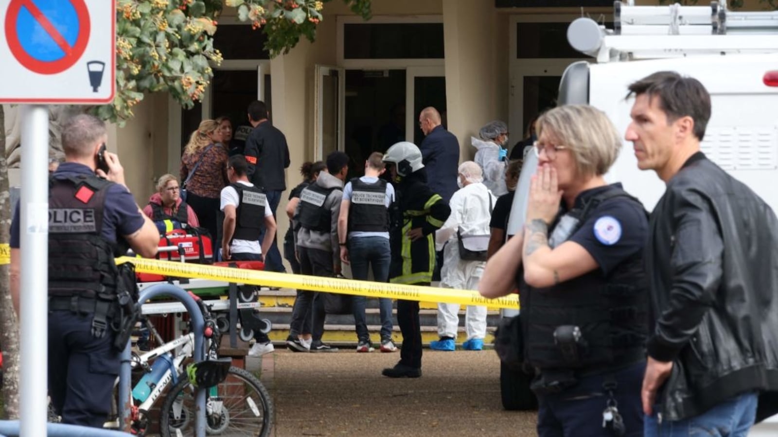 French police officers from the forensic service stand in front of the Gambetta high school in Arras, northeastern France on October 13, 2023.