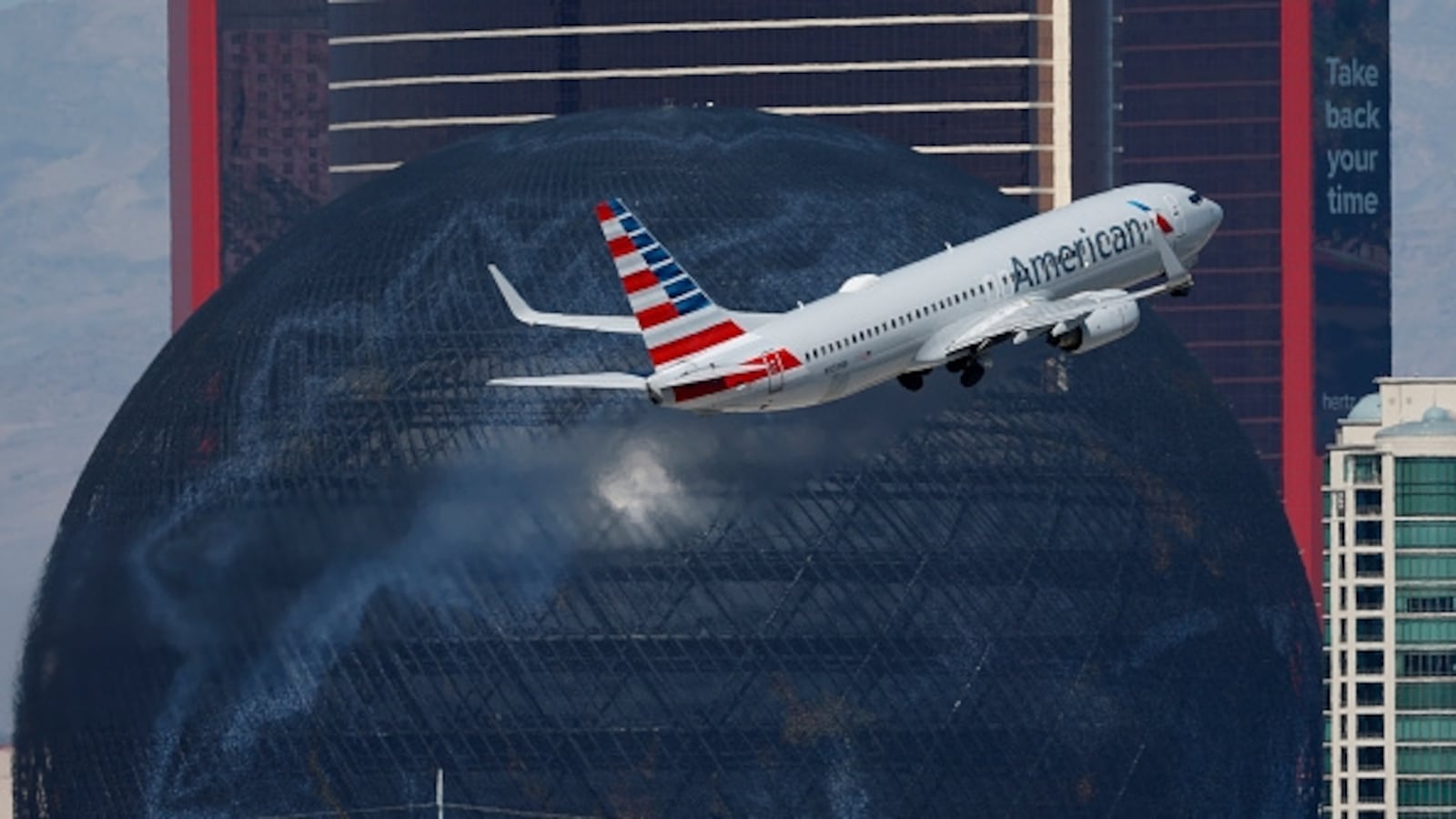 LAS VEGAS, NEVADA - MARCH 11: An American Airlines Boeing 737 departs from Harry Reid International Airport en route to Chicago with the Sphere in the background on March 11, 2026 in Las Vegas, Nevada