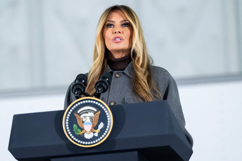 US First Lady Melania Trump speaks prior to making care packages for deployed members of the US military during an American Red Cross holiday event with military families at Joint Base Andrews in Maryland, December 1, 2025.