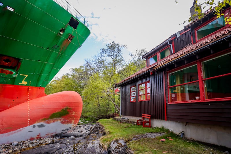 A picture shows a 135-meter-long container ship by the shore in the Trondheimsfjord outside Byneset by Trondheim, Norway, on May 22, 2025, after it ran aground almost hitting a house. (Photo by Jan Langhaug / NTB / AFP) / Norway OUT (Photo by JAN LANGHAUG/NTB/AFP via Getty Images)