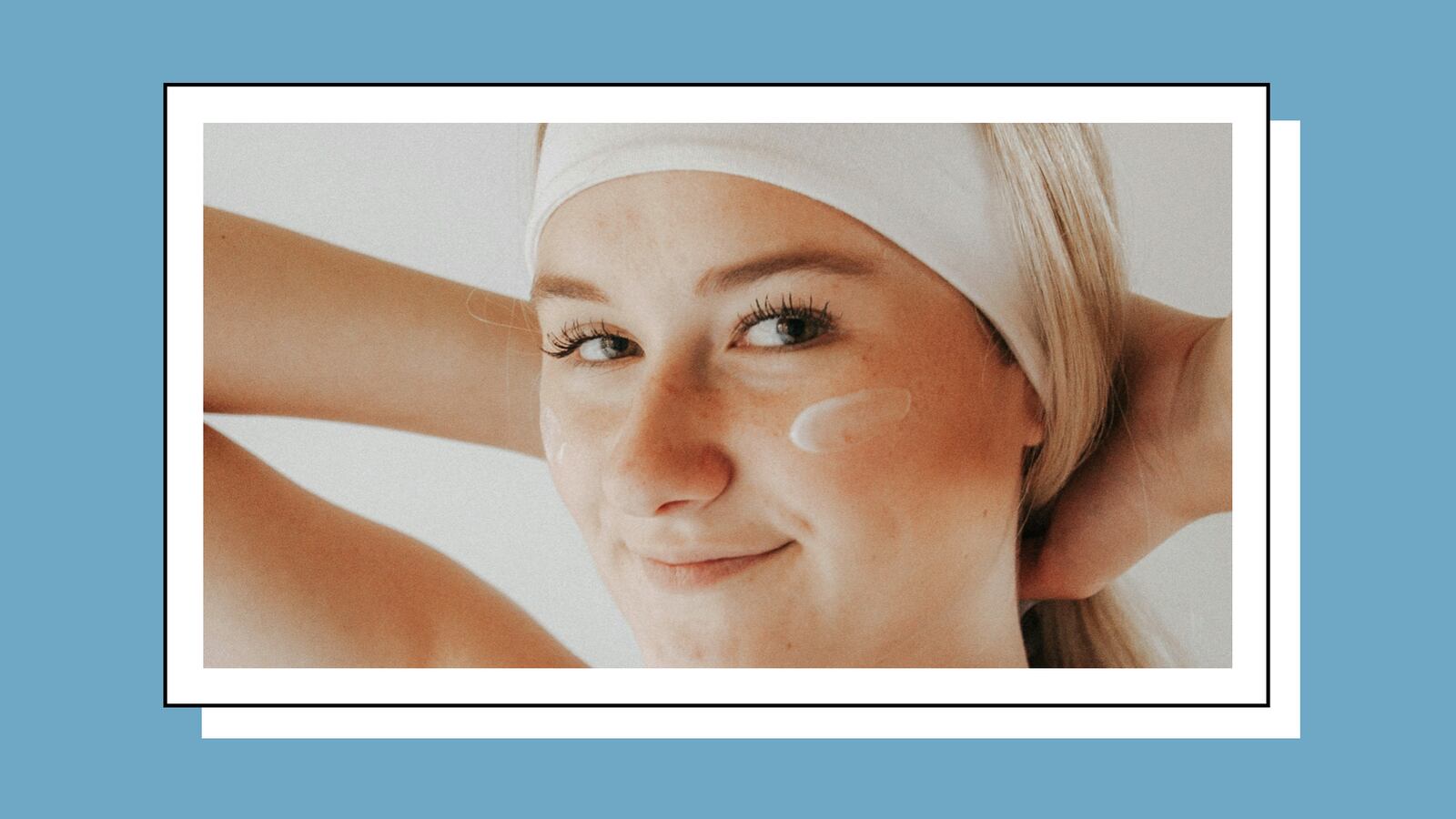 A smiling woman wearing a white tank top and headband.