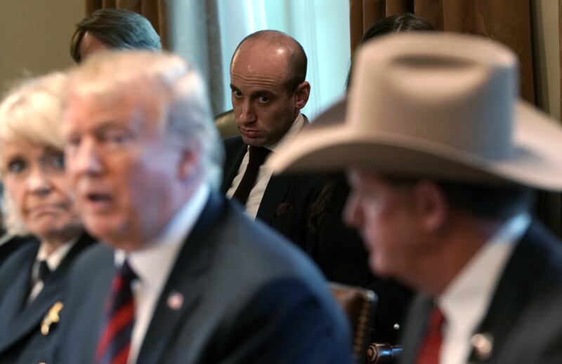 Senior Advisor to the President Stephen Miller (C) looks on as U.S. President Donald Trump hosts a round-table discussion