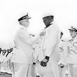 Admiral Chester W. Nimitz pinning Navy Cross on Doris "Dorie" Miller at ceremony aboard the USS Enterprise, Pearl Harbor, Hawaii, U.S. Office of War Information, May 27, 1942.