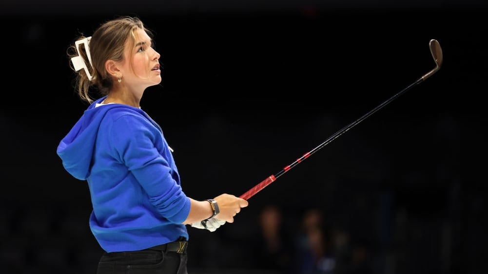 Kai Trump watches her shot.