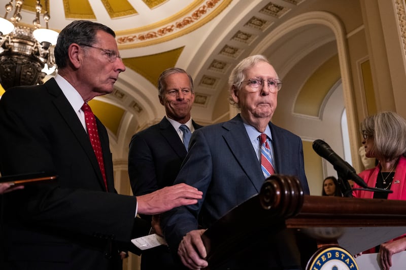 Senator John Barrasso (R-WY) reaches out to help then-Senate Minority Leader Mitch McConnell after McConnell froze and stopped talking at the microphones during a news conference after a lunch meeting with Senate Republicans U.S. Capitol 26, 2023 in Washington, DC. McConnell was escorted back to his office and later returned to the news conference and answered questions.