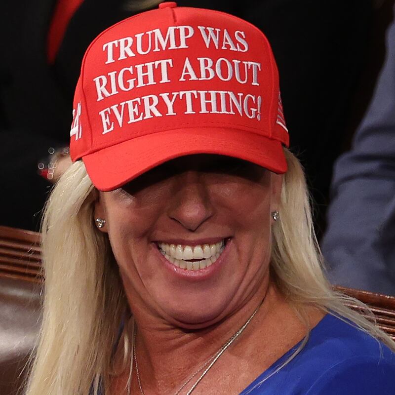 Marjorie Taylor Greene wearing a red hat reading "Trump was right about everything" at the U.S. Capitol.