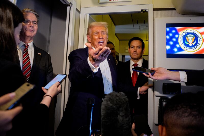 President Donald Trump, accompanied by U.S. Secretary of State Marco Rubio (R) and U.S. Treasury Secretary Scott Bessent (L), speaks to members of the media aboard Air Force One on October 27, 2025, in flight. Trump is in route to Japan after attending the Association of Southeast Asian Nations (ASEAN) summit in Malaysia,
