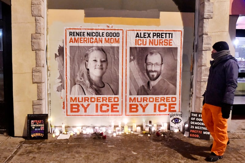 Posters of Renee Nicole Good and Alex Pretti, both US citizens fatally shot by immigration agents, are seen during a candlelight vigil in Minneapolis, Minnesota.