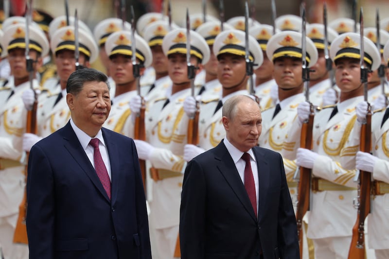Russian President Vladimir Putin and Chinese President Xi Jinping inspect an honor guard during a welcoming ceremony at the Great Hall of the People in Beijing, China May 20, 2026.