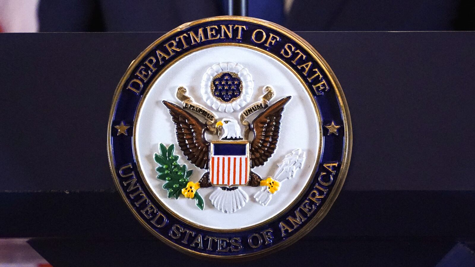 The seal of the U.S. State Department is seen on a lectern