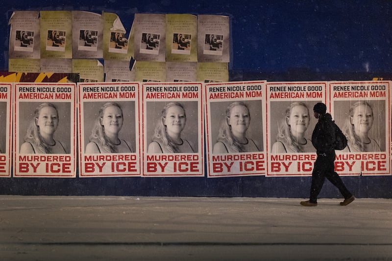 A man walks by a series of posters memorializing Renee Good on January 16, 2026 in Minneapolis, Minnesota.