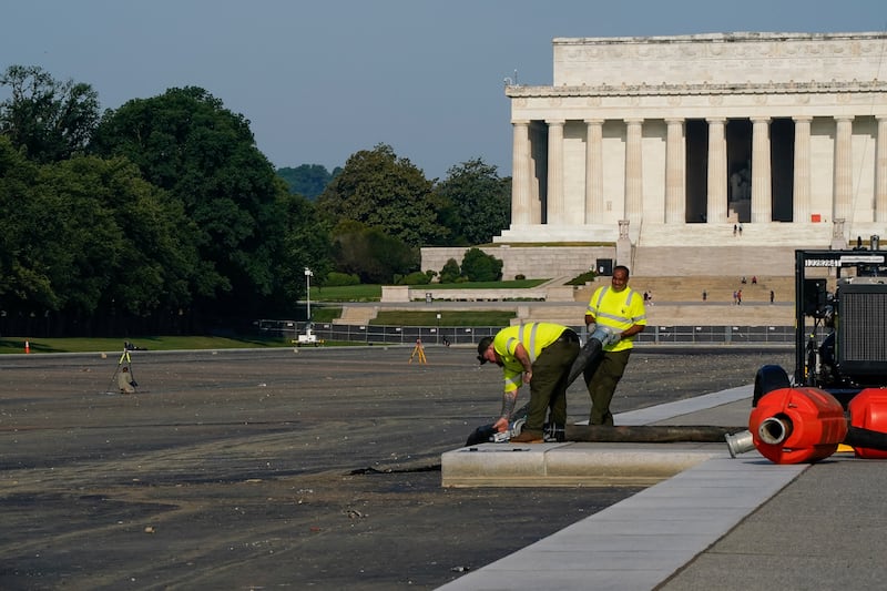 Workers remove equipment from the drained Lincoln Memorial Reflecting Pool on July 15, 2026.