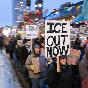Demonstrators march during the nationwide "Stop ICE Terror" rally through downtown Minneapolis, Minnesota, on Jan. 20, 2026 in protest against US President Donald Trump's policies.