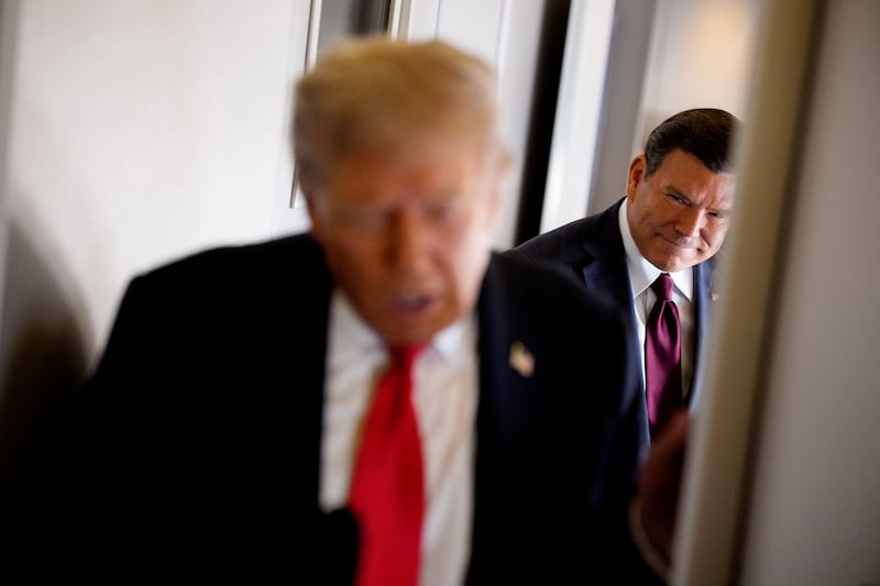 U.S. President Donald Trump (L), accompanied by FOX News journalist Bret Baier (R), speaks to members of the media aboard Air Force One on August 15, 2025, in flight.